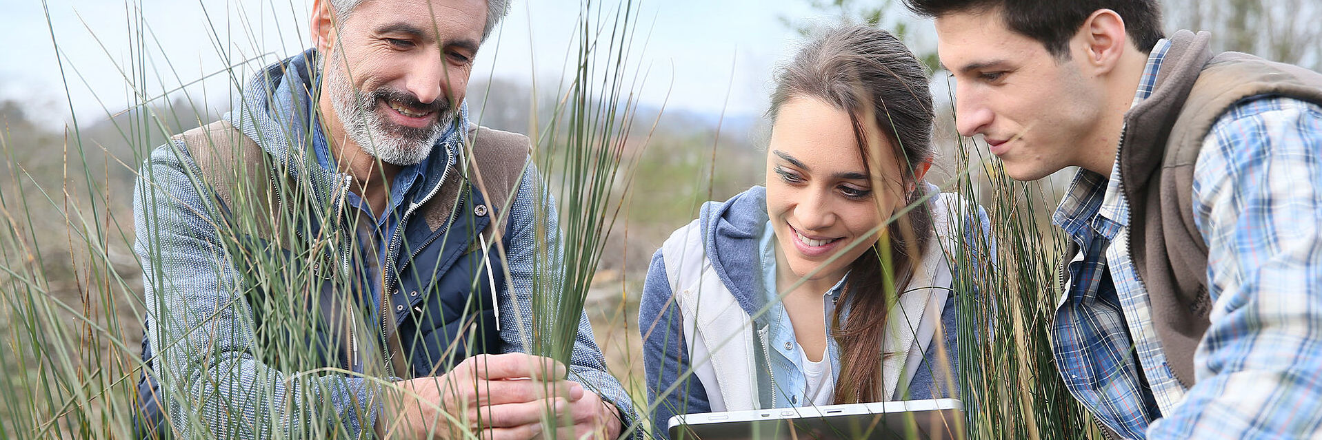 Teacher with students in agronomy looking at vegetation